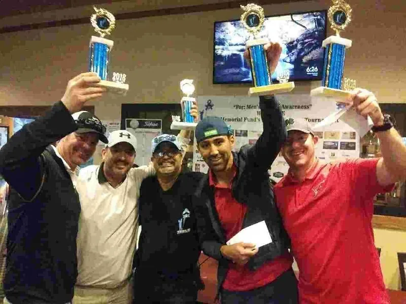 A winning team with their trophies at the Fund's golf tournament